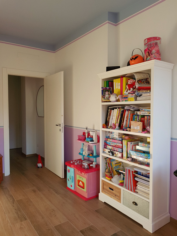 Inredning av ett modernt stort flickrum kombinerat med sovrum och för 4-10-åringar, med flerfärgade väggar, klinkergolv i porslin och brunt golv