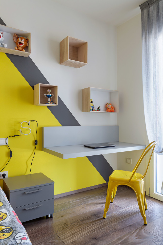 Scandinavian gender neutral kids' bedroom in Bologna with multi-coloured walls and medium hardwood flooring.