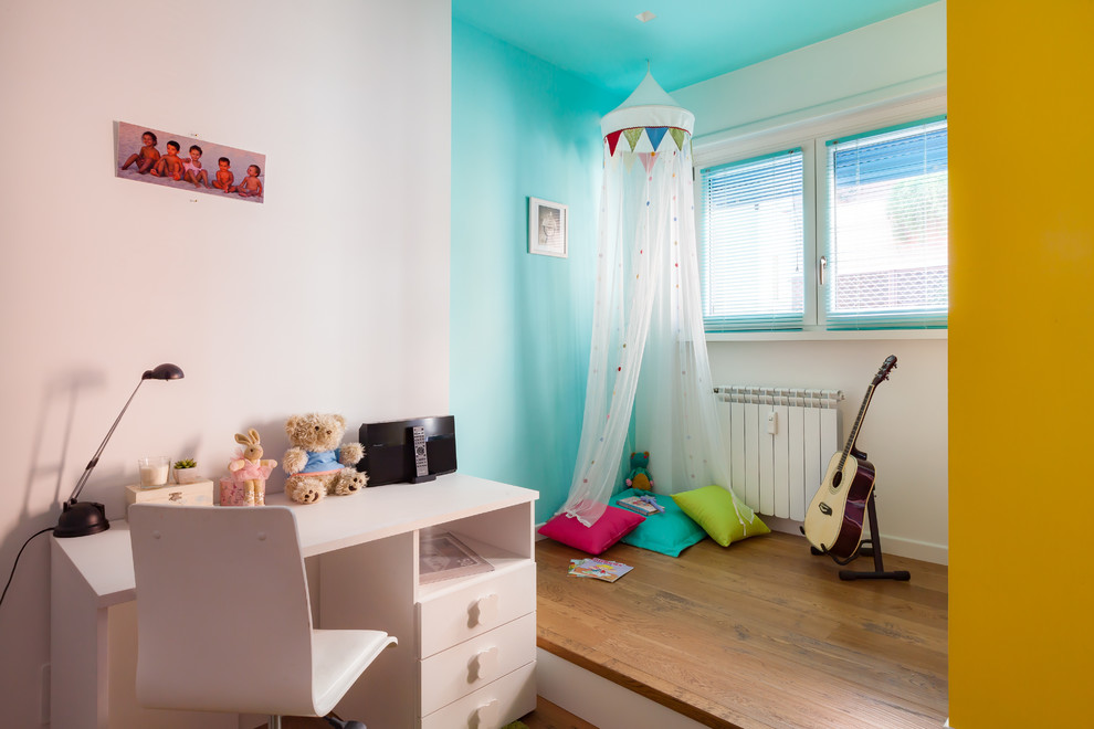 Small contemporary gender neutral kids' bedroom in Rome with multi-coloured walls.