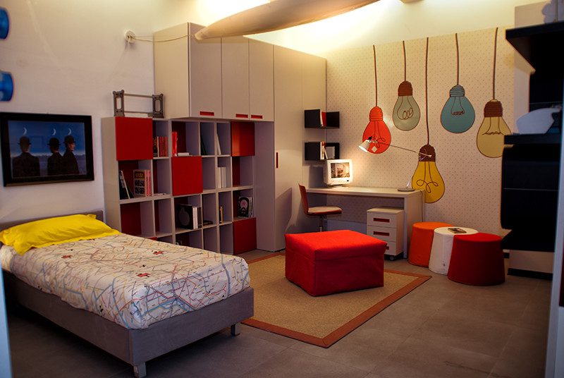 Design ideas for a medium sized modern gender neutral children’s room in Naples with white walls.