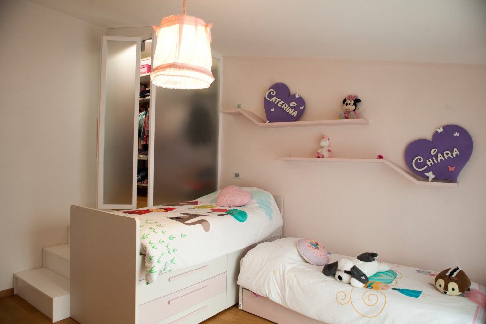 Kids' room - huge modern girl medium tone wood floor kids' room idea in Other with pink walls
