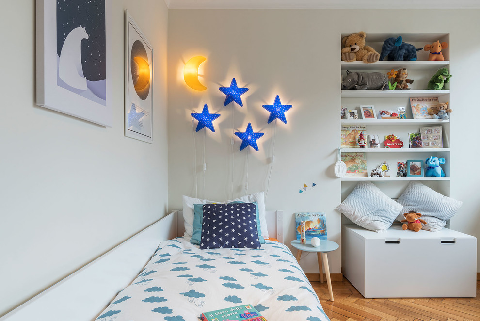 Esempio di una cameretta per bambini da 1 a 3 anni scandinava con pareti bianche e pavimento in legno massello medio