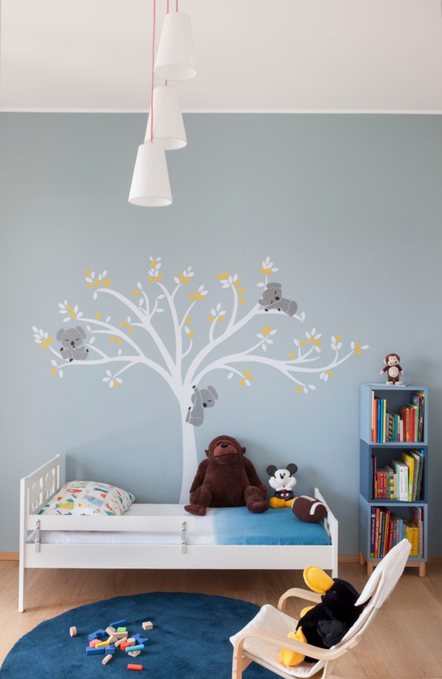 Idee per una cameretta per bambini da 4 a 10 anni contemporanea di medie dimensioni con pareti blu e pavimento beige