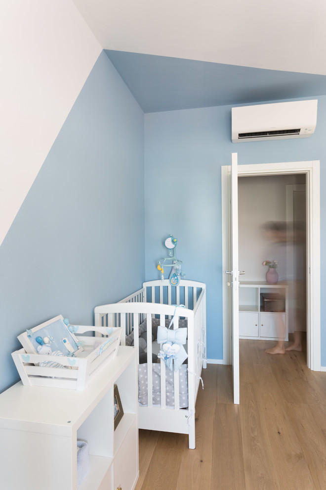 Idee per una cameretta per bambini da 1 a 3 anni minimal di medie dimensioni con pareti multicolore e parquet chiaro