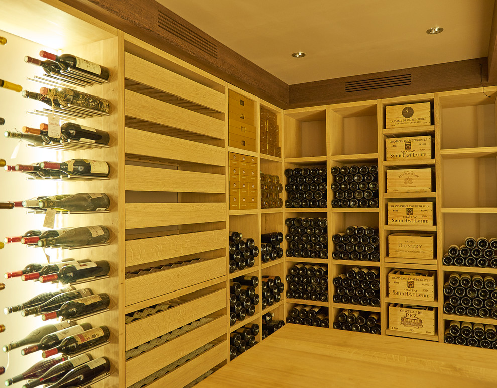 This is an example of a medium sized contemporary wine cellar in Angers with storage racks.