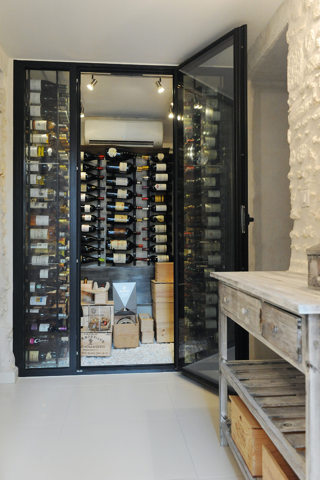 Photo of a small contemporary wine cellar in Other with display racks.