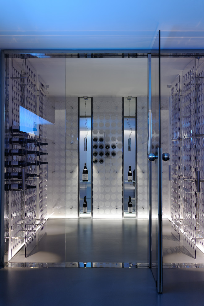 Trendy concrete floor wine cellar photo in Lyon with storage racks