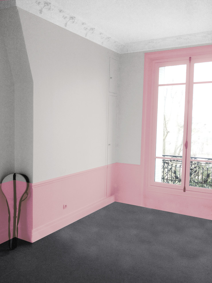 This is an example of a medium sized contemporary children’s room for girls in Paris with pink walls and carpet.