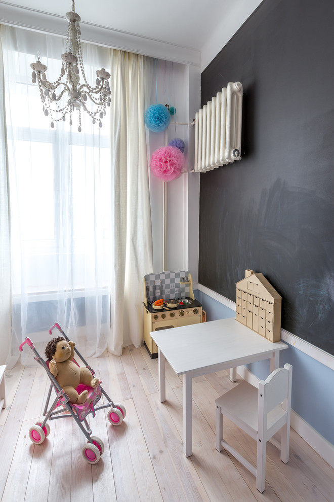 Réalisation d'une chambre d'enfant design avec parquet clair et un mur multicolore.