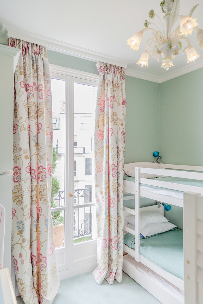 This is an example of a bohemian gender neutral children’s room in Paris with green walls.