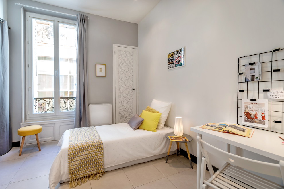 Photo of a medium sized scandi gender neutral teen’s room in Marseille with ceramic flooring and grey walls.