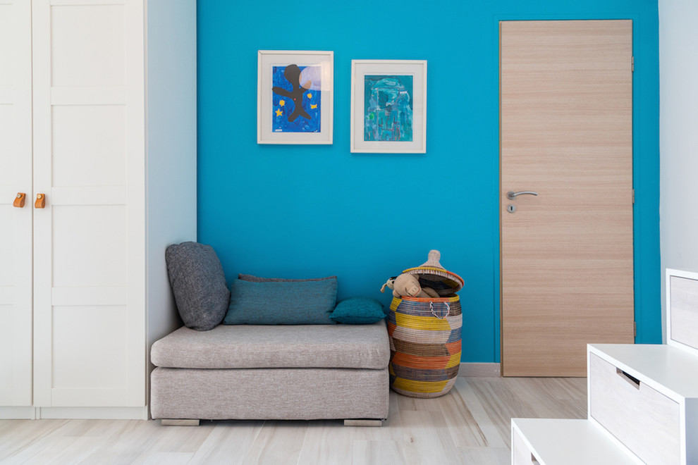 Design ideas for a large contemporary children’s room for boys in Nice with blue walls and light hardwood flooring.