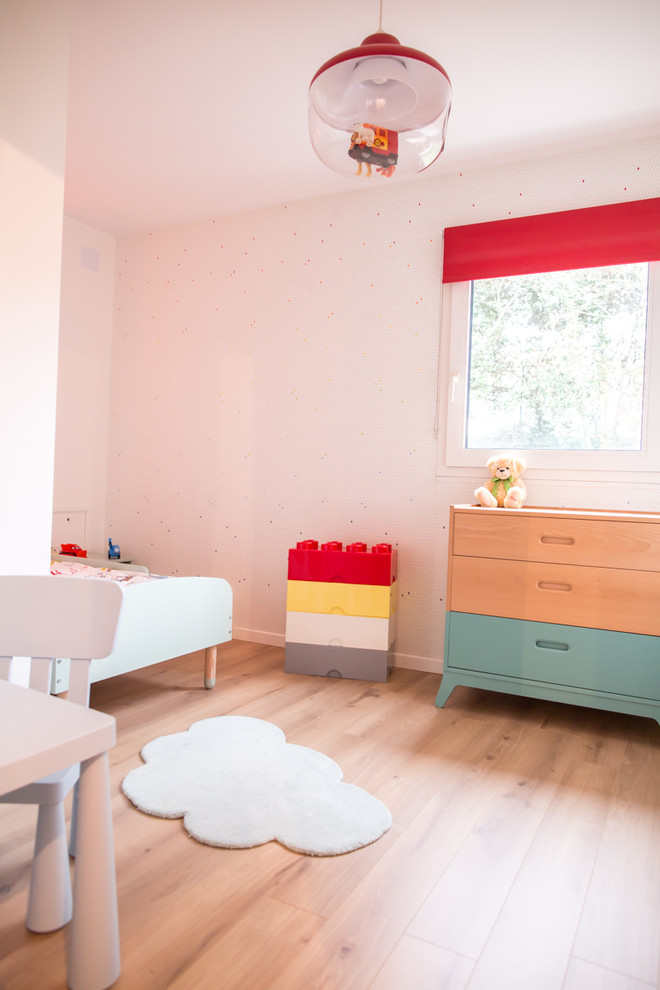 This is an example of a small contemporary kids' bedroom for boys in Paris with white walls and white floors.