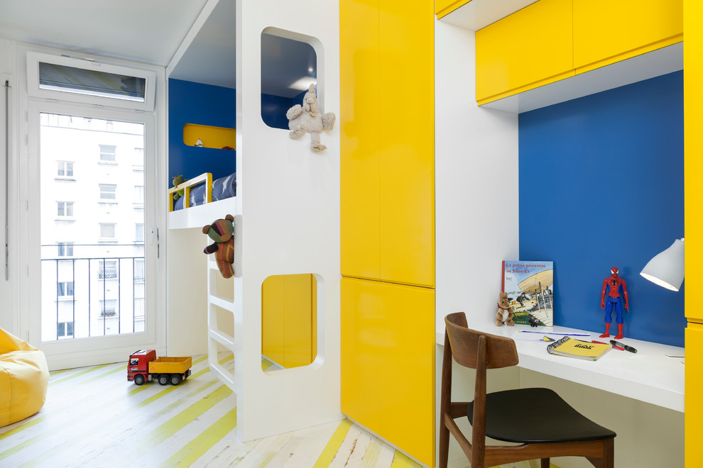 Пример оригинального дизайна: детская среднего размера в современном стиле с рабочим местом, синими стенами, деревянным полом и разноцветным полом для мальчика, ребенка от 4 до 10 лет