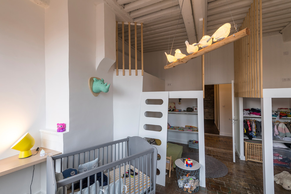 Example of a trendy gender-neutral terra-cotta tile kids' room design in Lyon with white walls