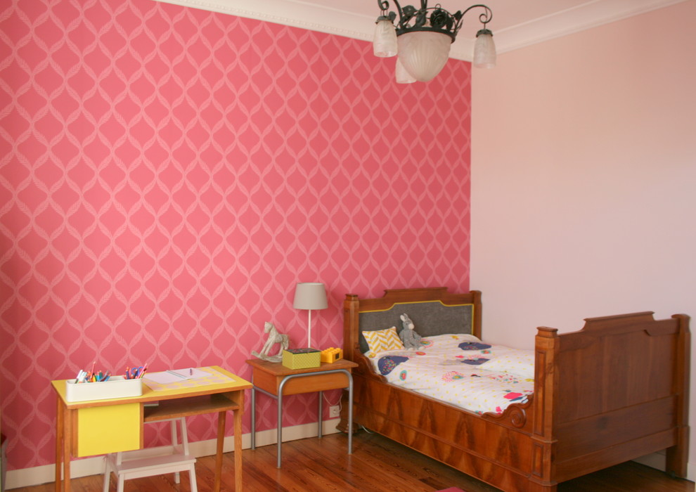 Aménagement d'une chambre d'enfant de 4 à 10 ans éclectique avec un mur rose et parquet clair.