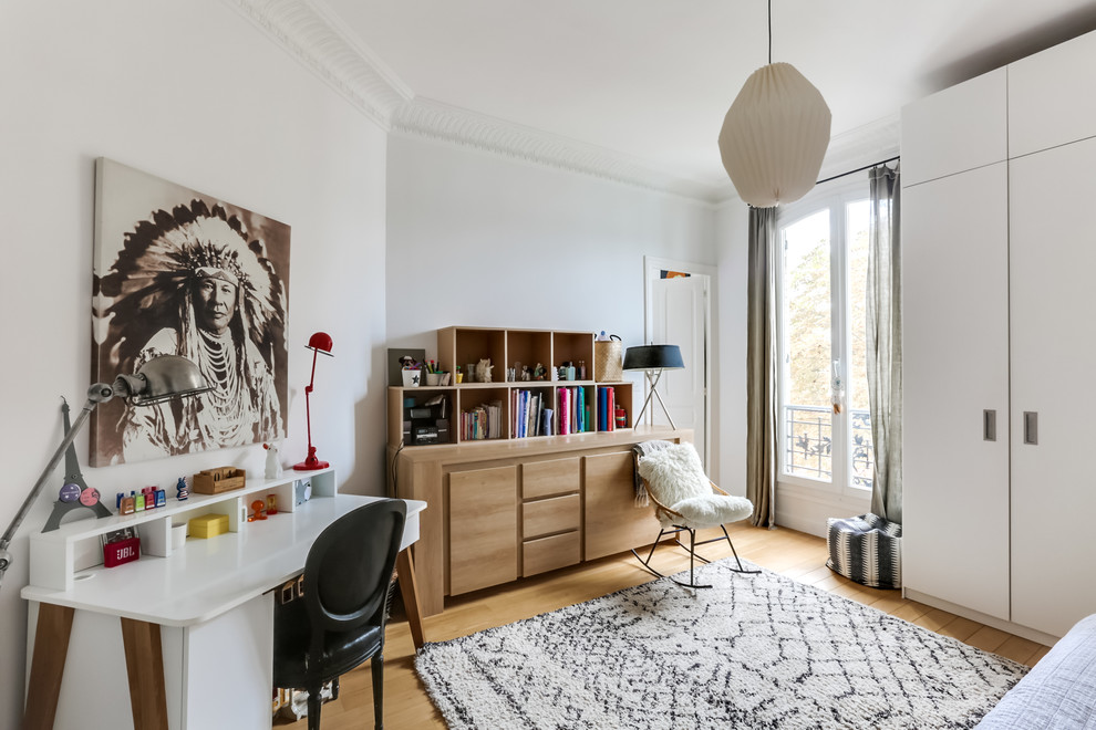 Example of a mid-sized danish girl light wood floor kids' room design in Paris with white walls