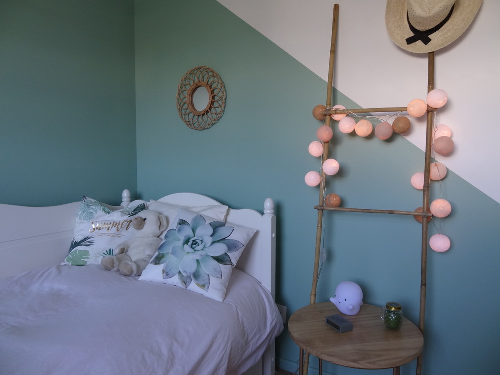 Example of a mid-sized island style girl light wood floor and beige floor kids' room design in Angers with green walls