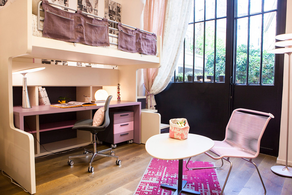 Medium sized bohemian kids' bedroom for girls in Paris with beige walls and medium hardwood flooring.
