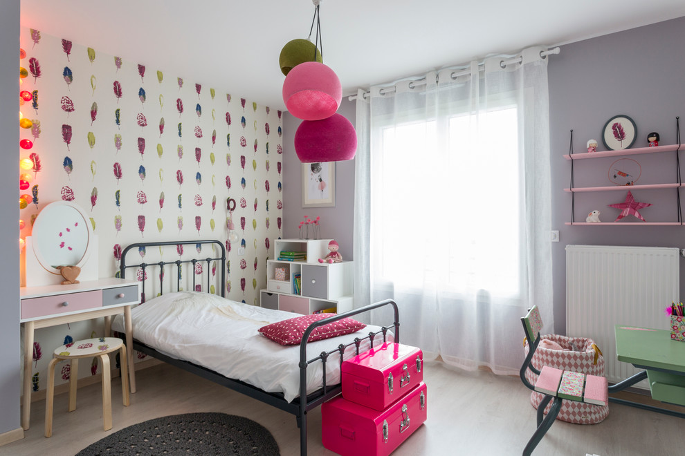 Imagen de dormitorio infantil de 4 a 10 años actual de tamaño medio con suelo de madera clara y paredes multicolor