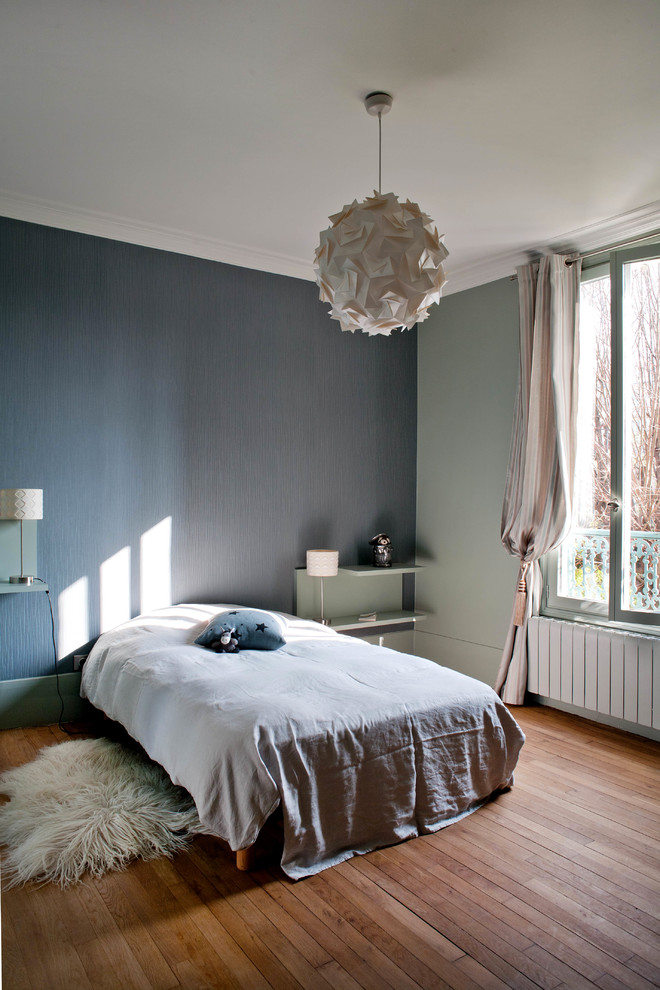 Example of a large trendy girl medium tone wood floor kids' room design in Paris with gray walls