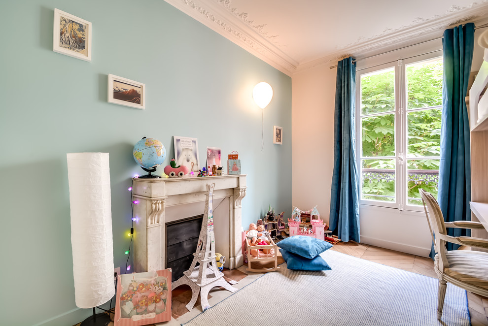 This is an example of a traditional kids' bedroom in Paris with blue walls.