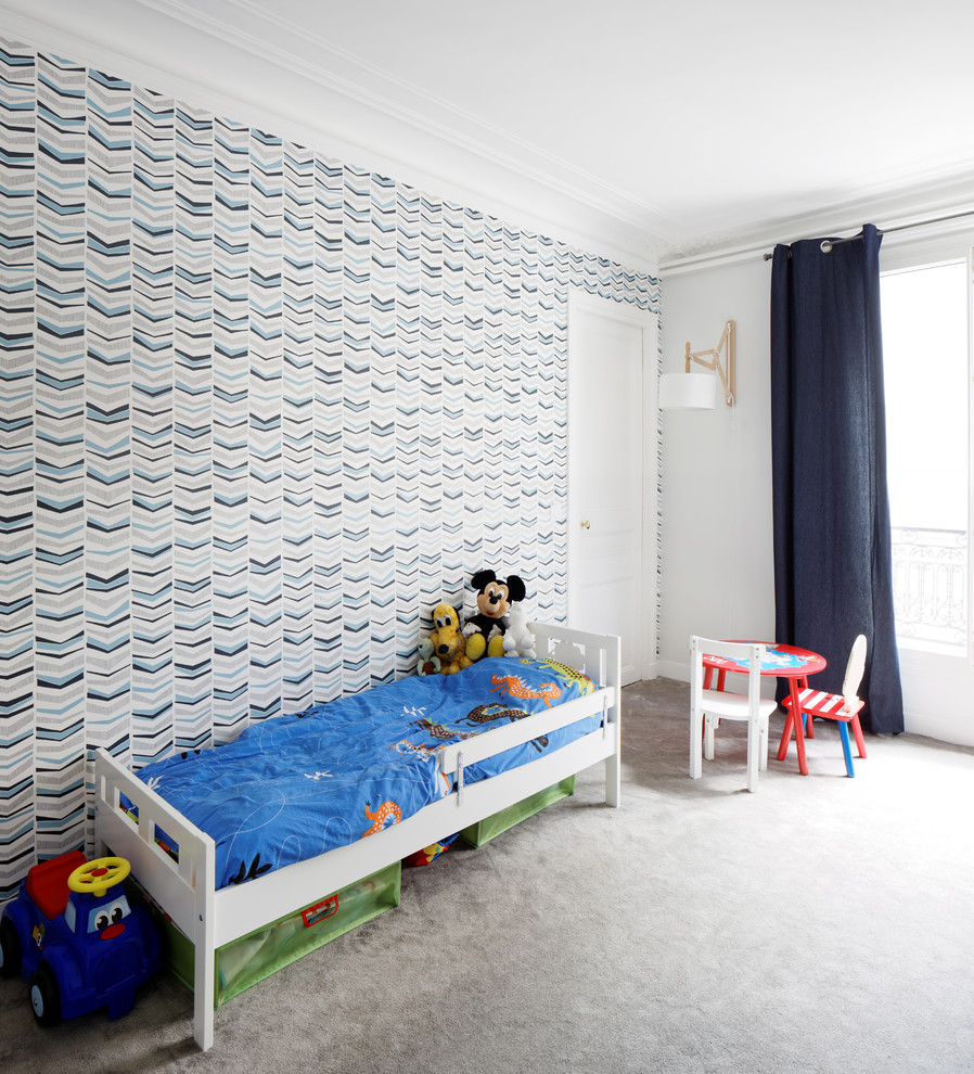 Large contemporary children’s room for boys in Paris with blue walls and carpet.