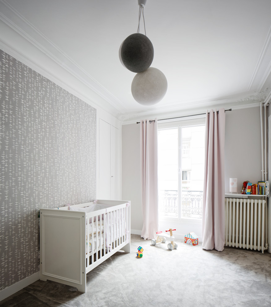 This is an example of a large contemporary nursery for girls in Paris with grey walls and carpet.