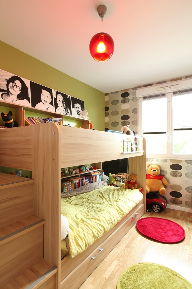 Example of a small minimalist boy light wood floor and beige floor kids' room design in Paris with green walls