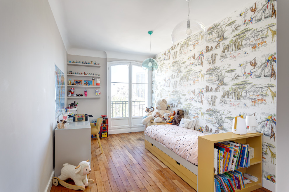Mid-sized elegant gender-neutral medium tone wood floor and brown floor kids' room photo in Other with beige walls
