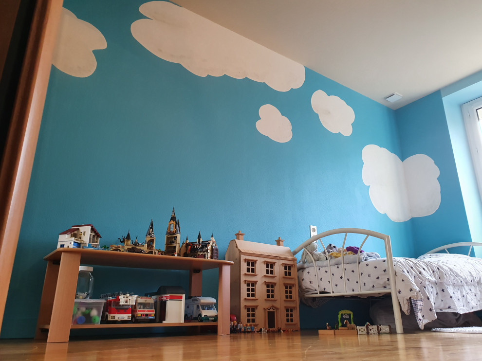 Design ideas for a medium sized children’s room for girls in Nantes with blue walls, laminate floors and beige floors.