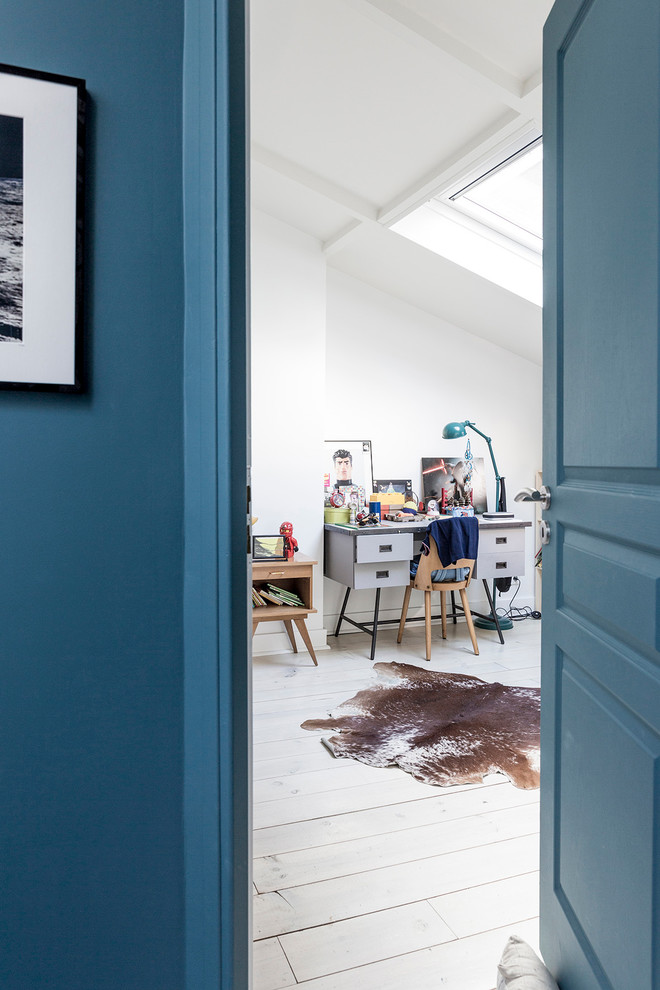 Cette image montre une chambre de garçon de 4 à 10 ans minimaliste de taille moyenne avec un bureau, un mur blanc et parquet clair.