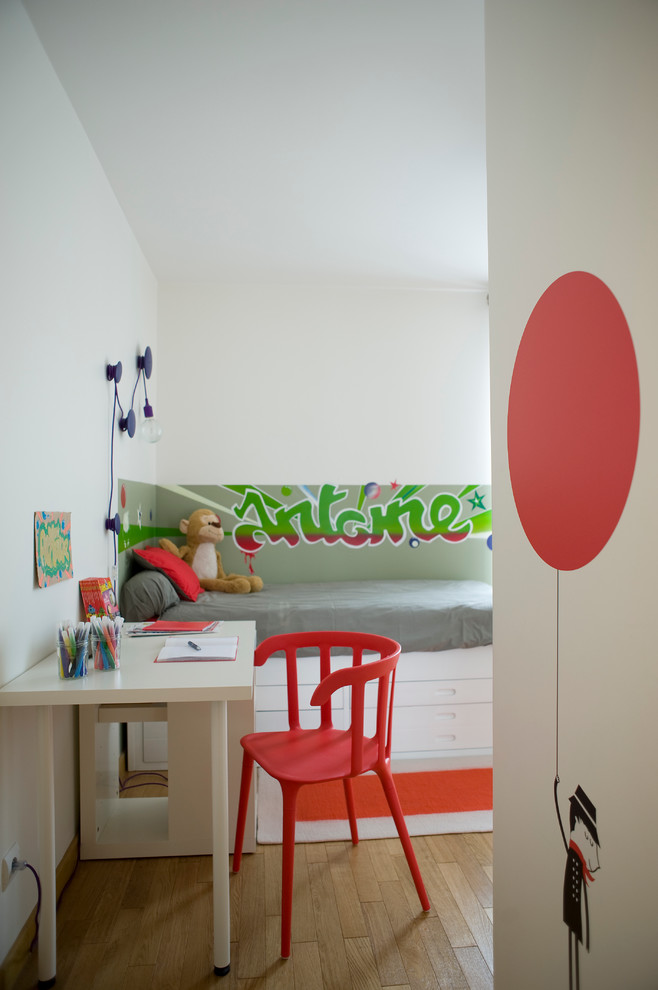 Mid-sized eclectic gender-neutral light wood floor kids' room photo in Paris with white walls