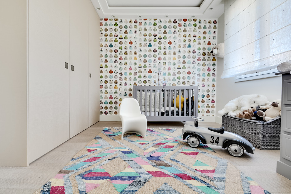 Inspiration for a scandinavian gender neutral nursery in Paris with beige walls, light hardwood flooring, beige floors and a feature wall.