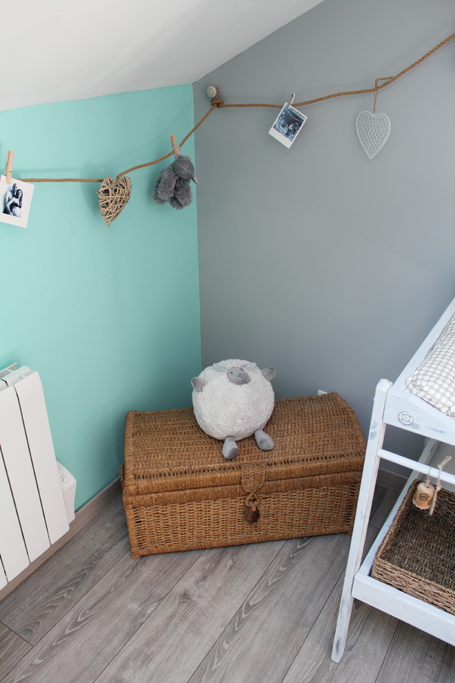 Design ideas for a medium sized farmhouse gender neutral nursery in Lille with light hardwood flooring and blue walls.