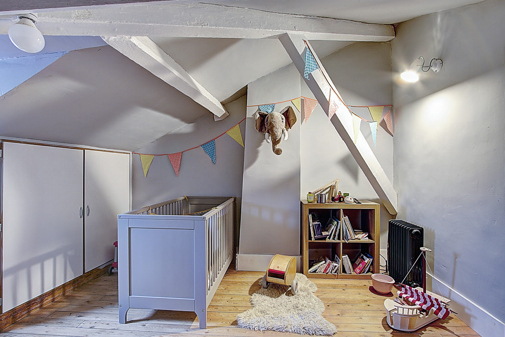 На фото: нейтральная комната для малыша среднего размера в стиле неоклассика (современная классика) с серыми стенами, светлым паркетным полом и бежевым полом с