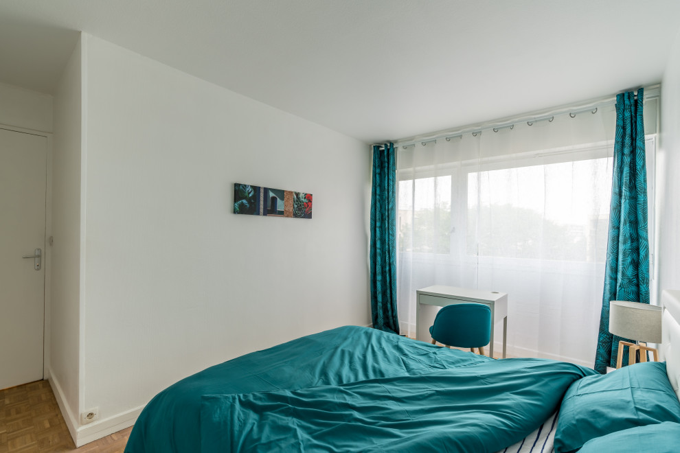 Imagen de dormitorio moderno pequeño con paredes blancas y suelo de madera clara