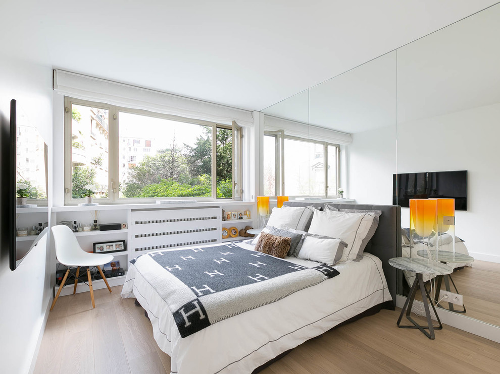 Design ideas for a medium sized scandinavian master bedroom in Paris with white walls and light hardwood flooring.