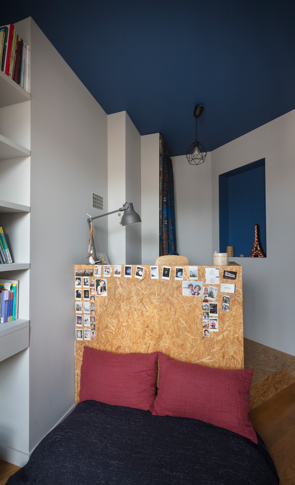 Kleines Modernes Hauptschlafzimmer mit weißer Wandfarbe, braunem Holzboden und beigem Boden in Paris