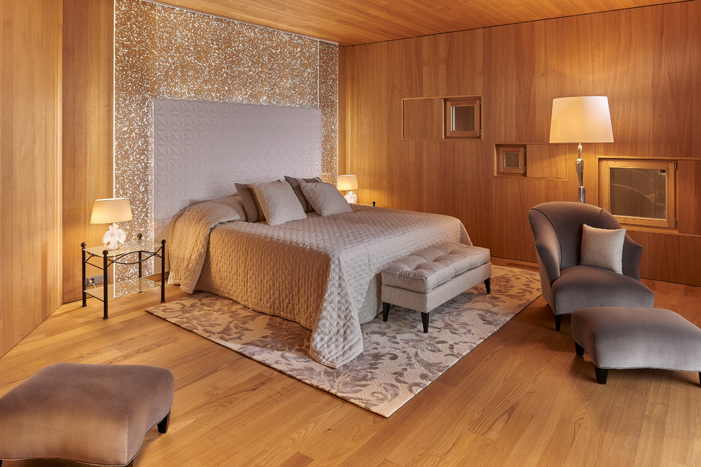 Rustic bedroom in Paris with brown walls, medium hardwood flooring and feature lighting.