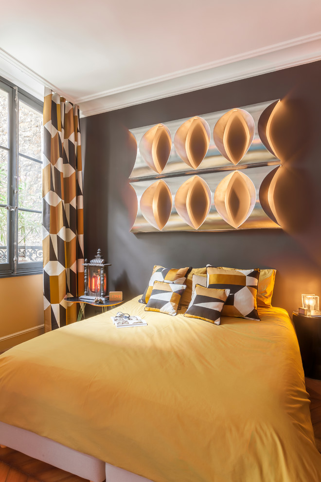 Design ideas for a medium sized eclectic master bedroom in Paris with brown walls and light hardwood flooring.