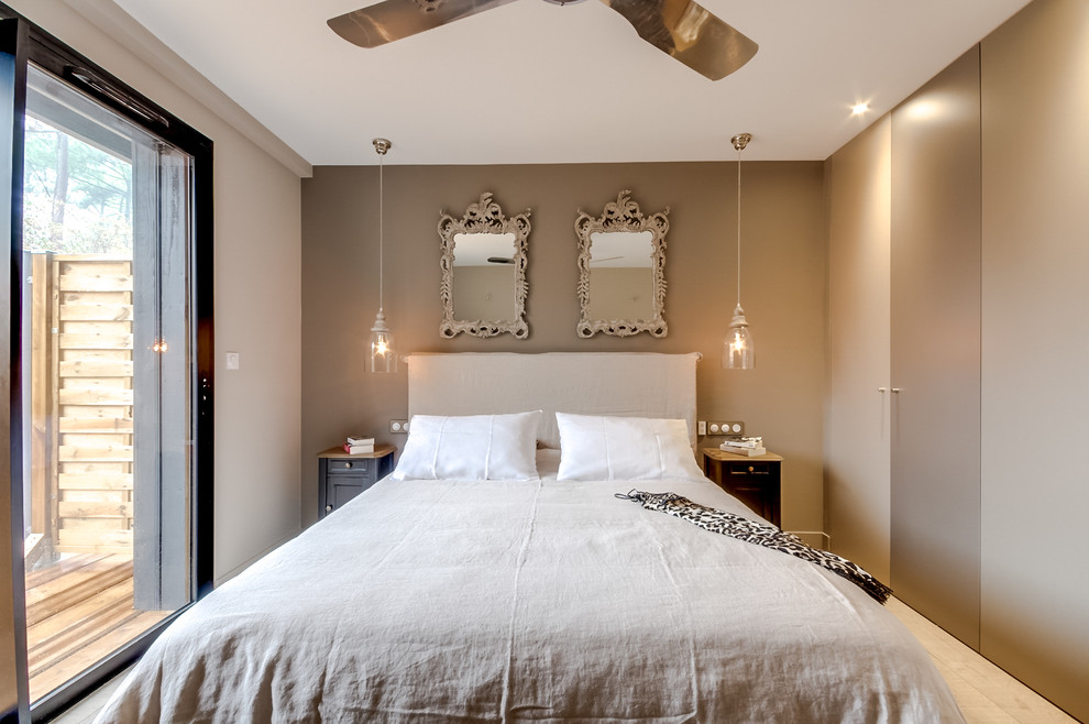 Mid-sized elegant master light wood floor and beige floor bedroom photo in Paris with beige walls and no fireplace