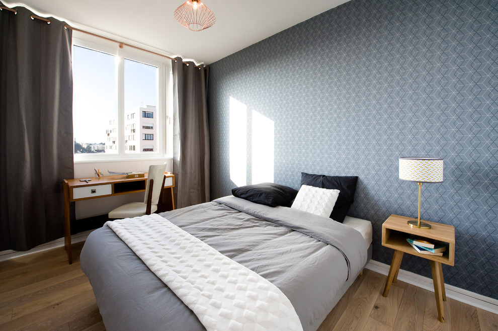 На фото: хозяйская спальня среднего размера в скандинавском стиле с паркетным полом среднего тона и синими стенами без камина
