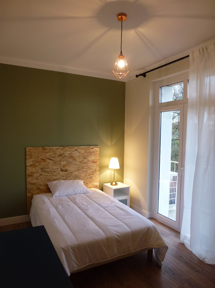 Photo of a large scandinavian master bedroom in Other with green walls, vinyl flooring and brown floors.