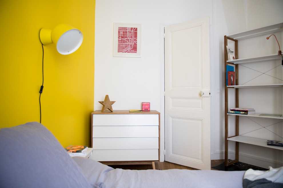 Foto de dormitorio principal tradicional renovado pequeño sin chimenea con paredes amarillas, suelo de madera clara y suelo marrón