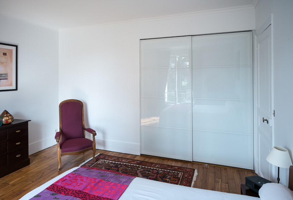 Aménagement d'une chambre parentale classique de taille moyenne avec un mur blanc et parquet clair.