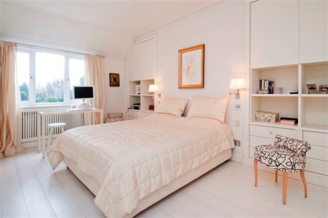 Inspiration for a large contemporary master bedroom in London with white walls, painted wood flooring and no fireplace.