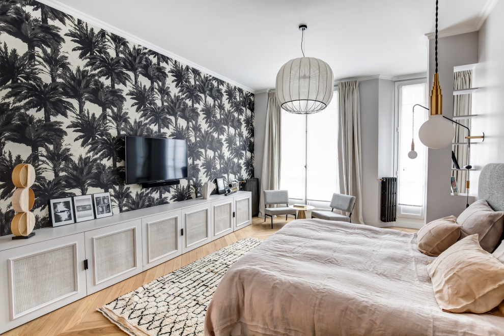 Photo of a contemporary master and grey and brown bedroom in Paris with multi-coloured walls, medium hardwood flooring, brown floors and wallpapered walls.