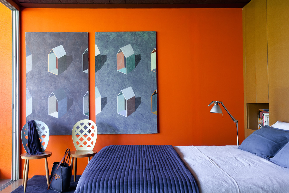 Contemporary bedroom in Paris with orange walls.