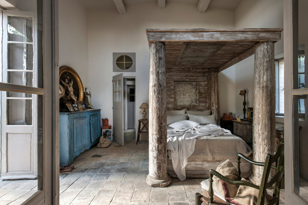 Example of a large country master bedroom design in Nice with white walls